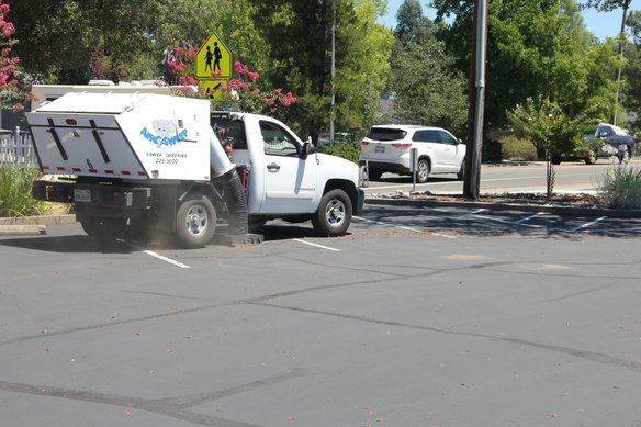 Sweeping A Leafy Parking Lot